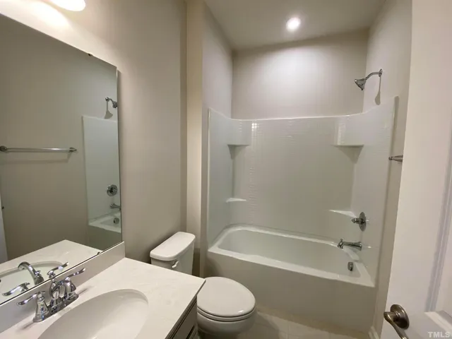 a bathroom with a toilet a sink and bathtub