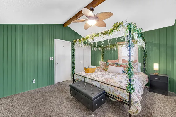 a bedroom with a bed table and window