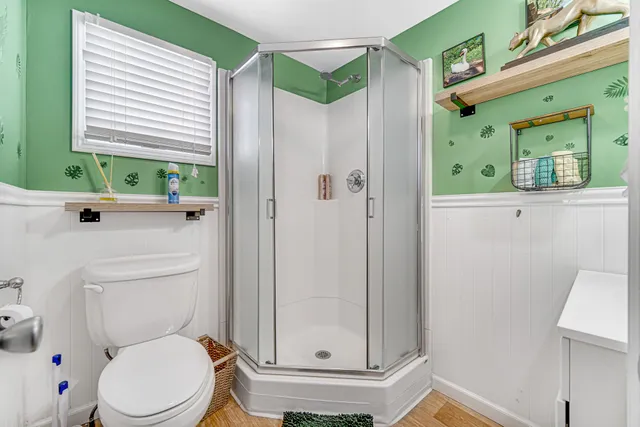 a bathroom with a toilet a sink and a window