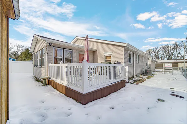 a view of a house with a wooden deck