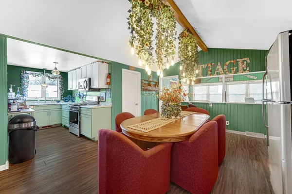 a kitchen with a sink cabinets and wooden floor