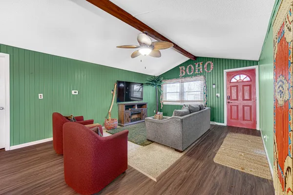 a living room with furniture and a flat screen tv