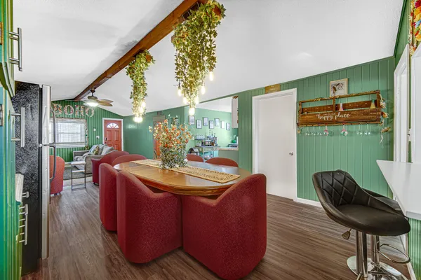 a dining room with furniture and wooden floor