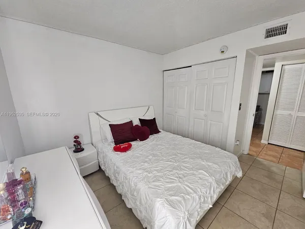 a bedroom with a bed and a mirror