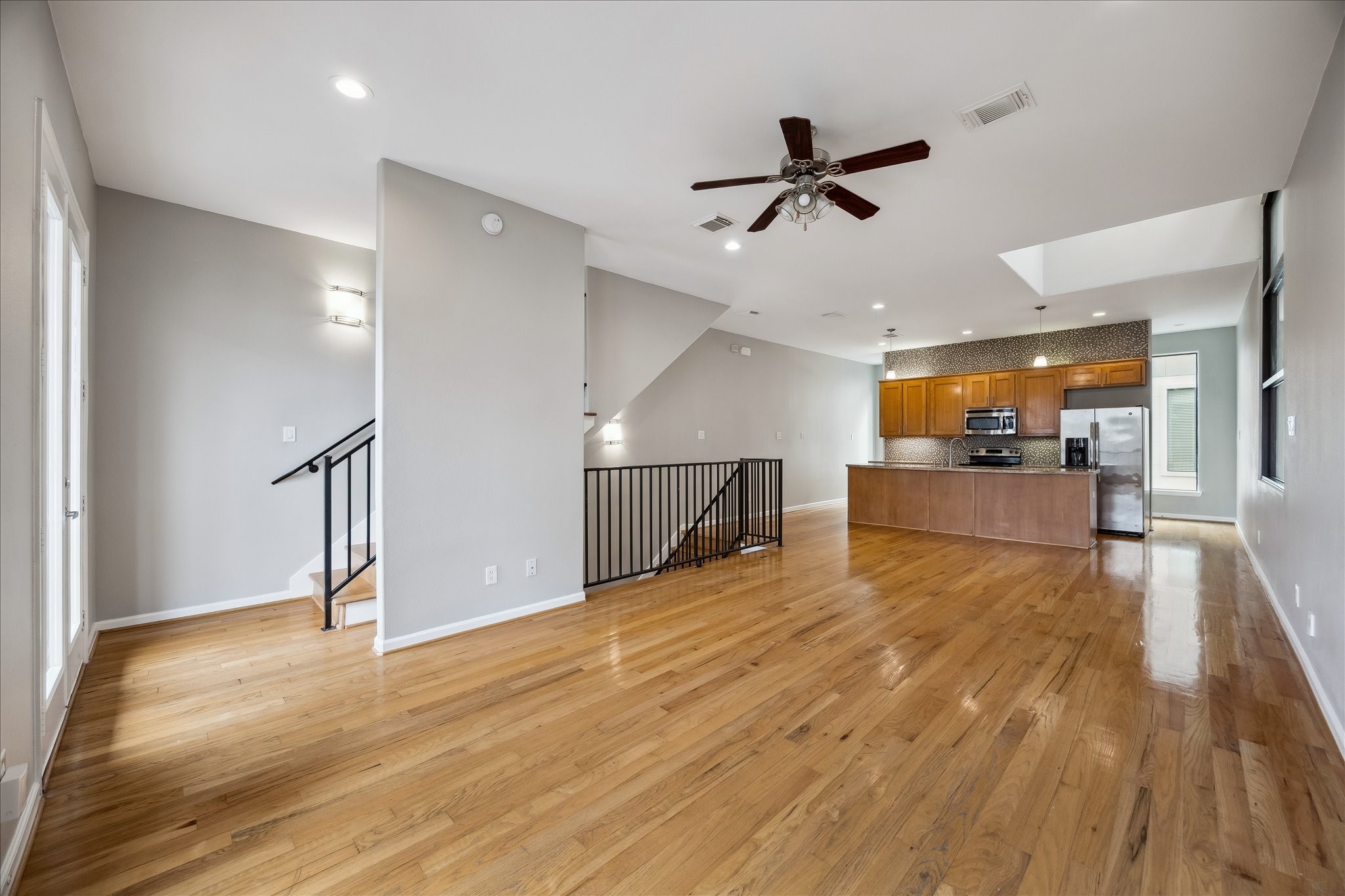 802 Waverly Street, Unit D Houston, TX 77007 - Photo 1 of 30 a view of a livingroom with wooden floor and a ceiling fan