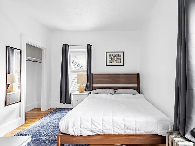 59-61 Glenwood Road, Unit 59 Somerville, MA 02145 - Photo 11 of 31 a bedroom with a bed and wooden floor