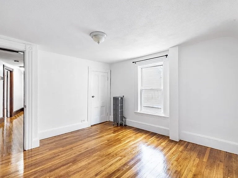 59-61 Glenwood Road, Unit 59 Somerville, MA 02145 - Photo 12 of 31 a view of empty room with wooden floor and fan