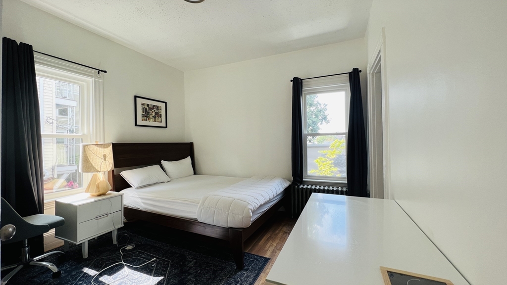 59-61 Glenwood Road, Unit 59 Somerville, MA 02145 - Photo 14 of 31 a bedroom with a bed and a window