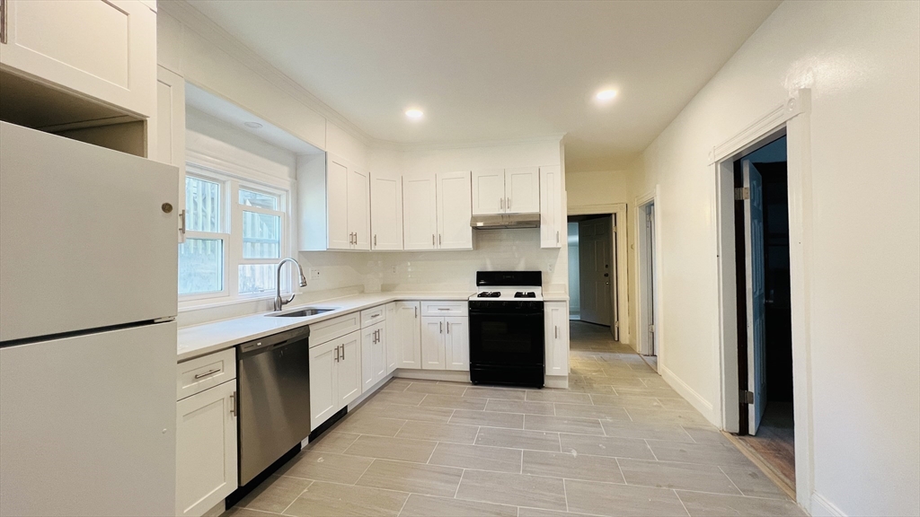 59-61 Glenwood Road, Unit 59 Somerville, MA 02145 - Photo 16 of 31 a kitchen with stainless steel appliances granite countertop a refrigerator and a sink