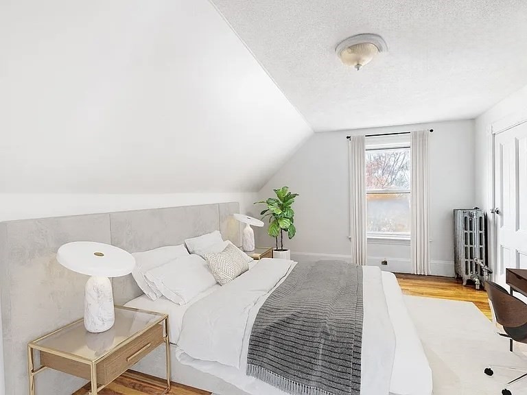 59-61 Glenwood Road, Unit 59 Somerville, MA 02145 - Photo 19 of 31 a bedroom with a bed and a chandelier