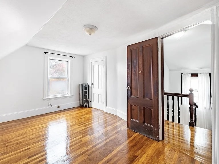 59-61 Glenwood Road, Unit 59 Somerville, MA 02145 - Photo 20 of 31 a view of a livingroom with wooden floor and a window