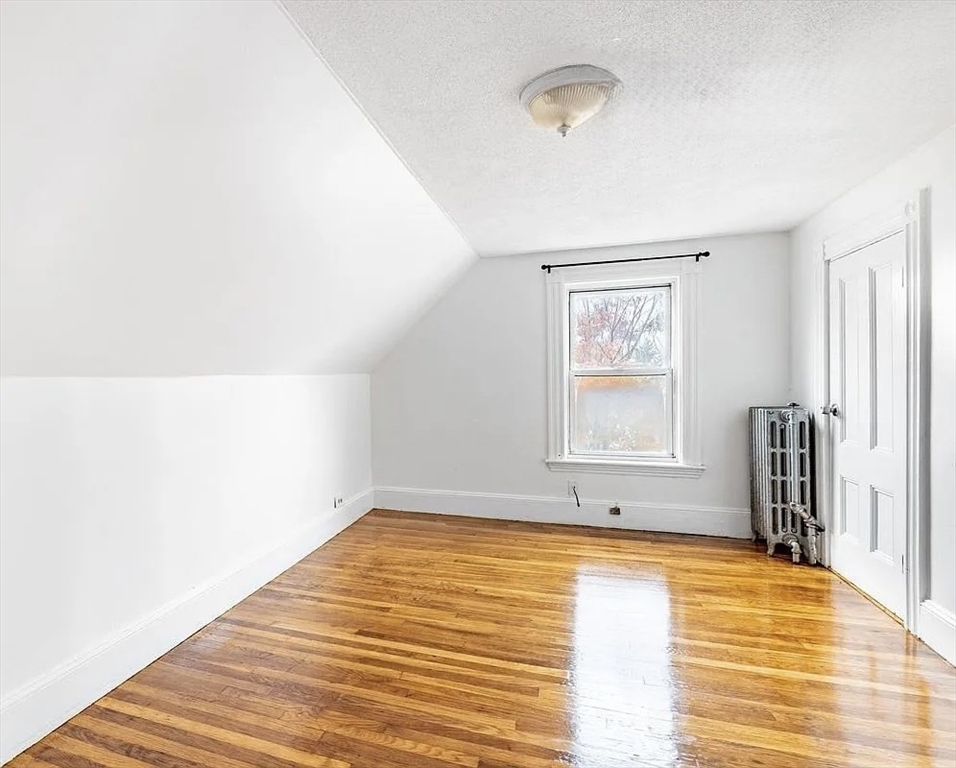59-61 Glenwood Road, Unit 59 Somerville, MA 02145 - Photo 21 of 31 a view of empty room with wooden floor and fan