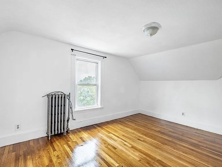 59-61 Glenwood Road, Unit 59 Somerville, MA 02145 - Photo 25 of 31 an empty room with a window and wooden floor
