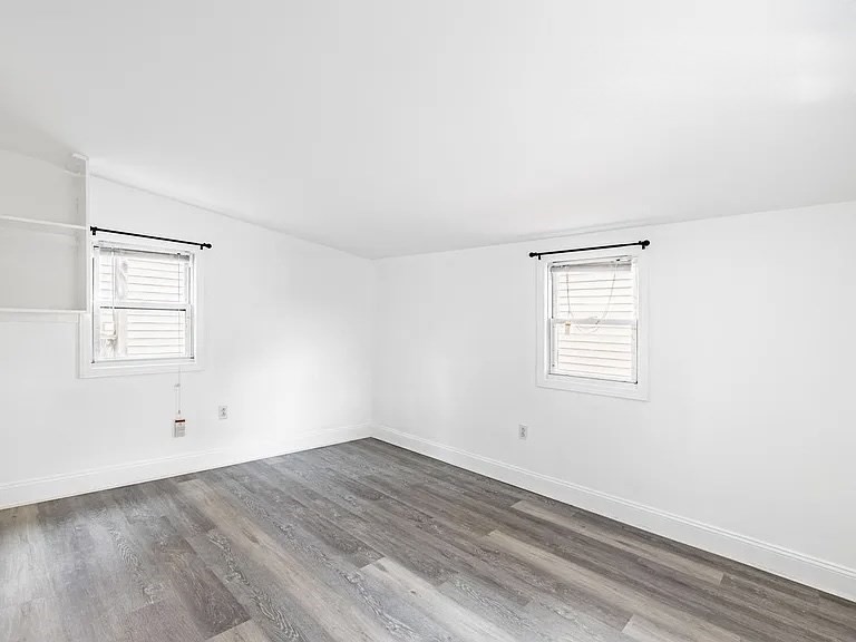 59-61 Glenwood Road, Unit 59 Somerville, MA 02145 - Photo 31 of 31 an empty room with wooden floor and windows