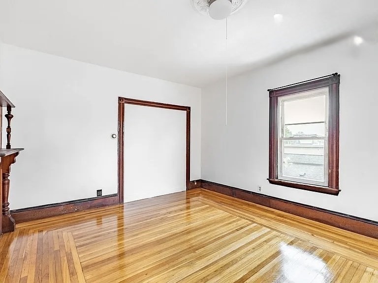 59-61 Glenwood Road, Unit 59 Somerville, MA 02145 - Photo 5 of 31 a view of an empty room with wooden floor and a window