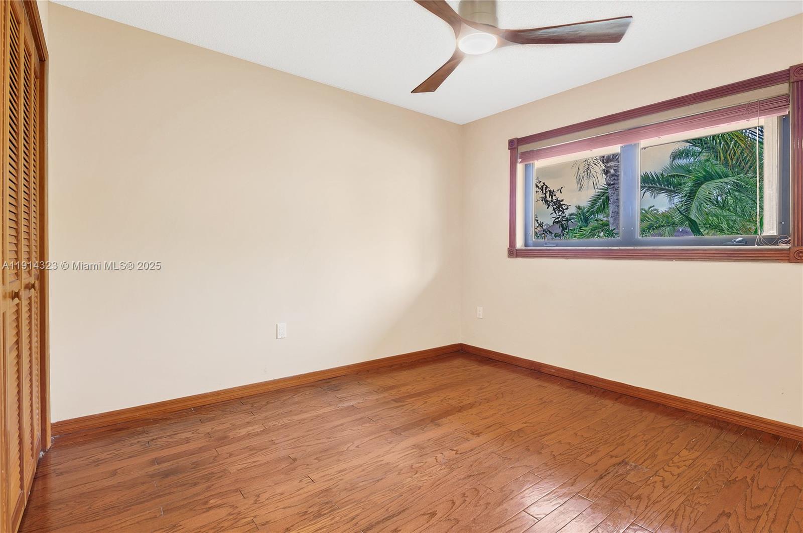 8035 Southwest 89th Court Miami, FL 33173 - Photo 21 of 31 a view of an empty room with wooden floor and a window