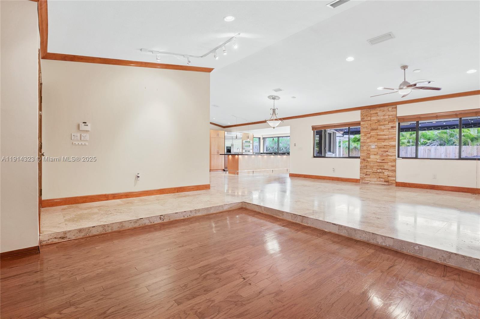 8035 Southwest 89th Court Miami, FL 33173 - Photo 5 of 31 an empty room with wooden floor and windows