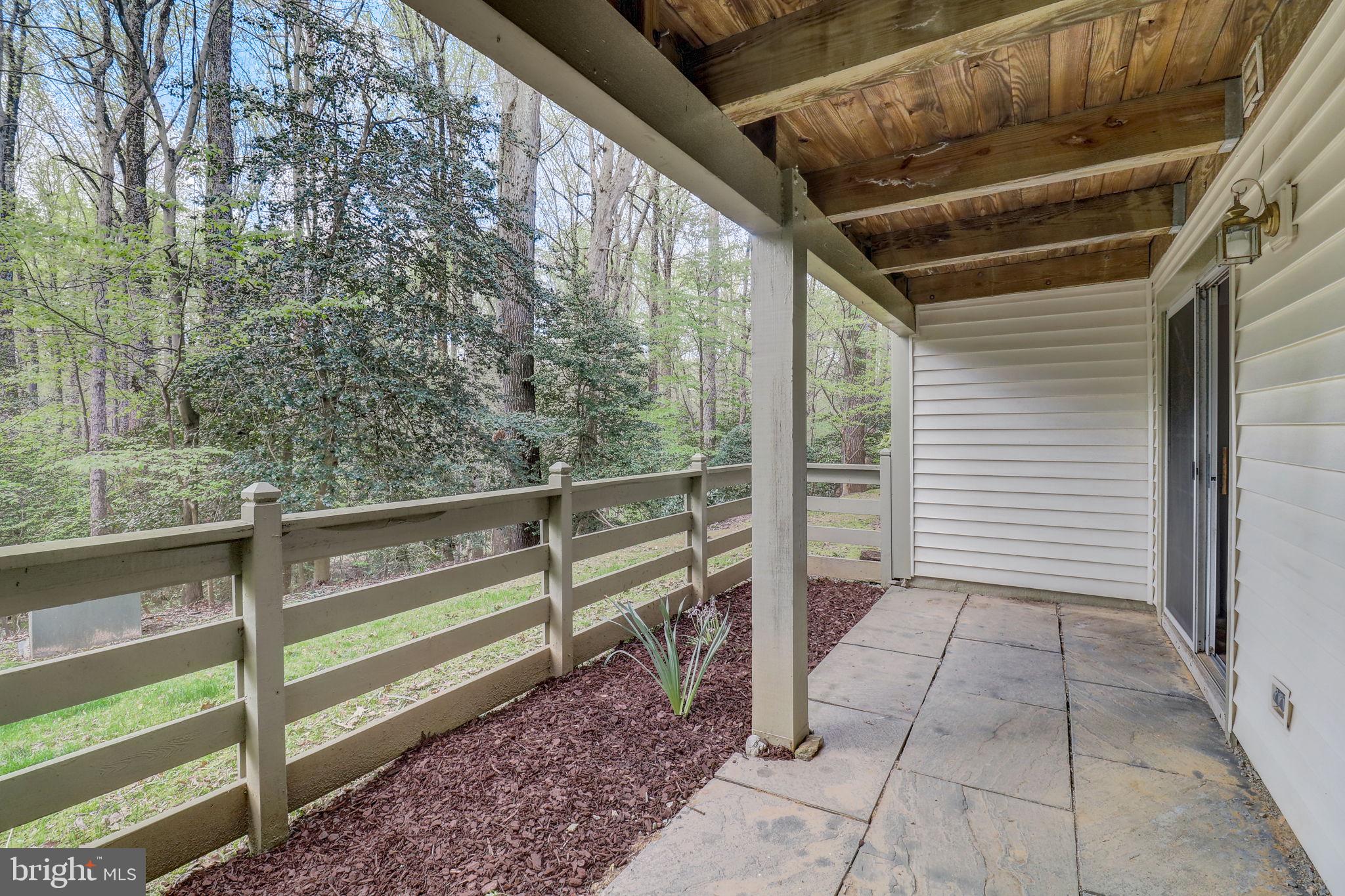 2237 Lovedale Lane, Unit 402B Reston, VA 20191 - Photo 4 of 36 Patio with garden area and wooded view