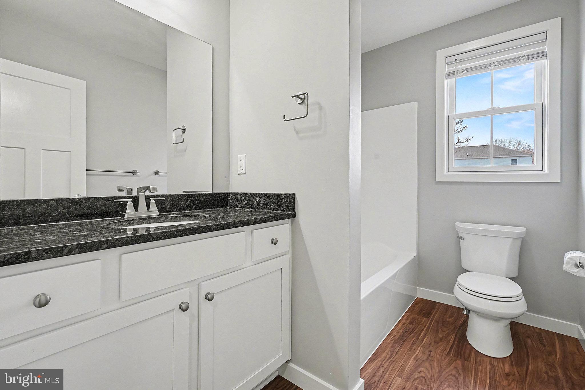 120 Hart Hershey, PA 17033 - Photo 12 of 16 a bathroom with a granite countertop toilet sink and mirror