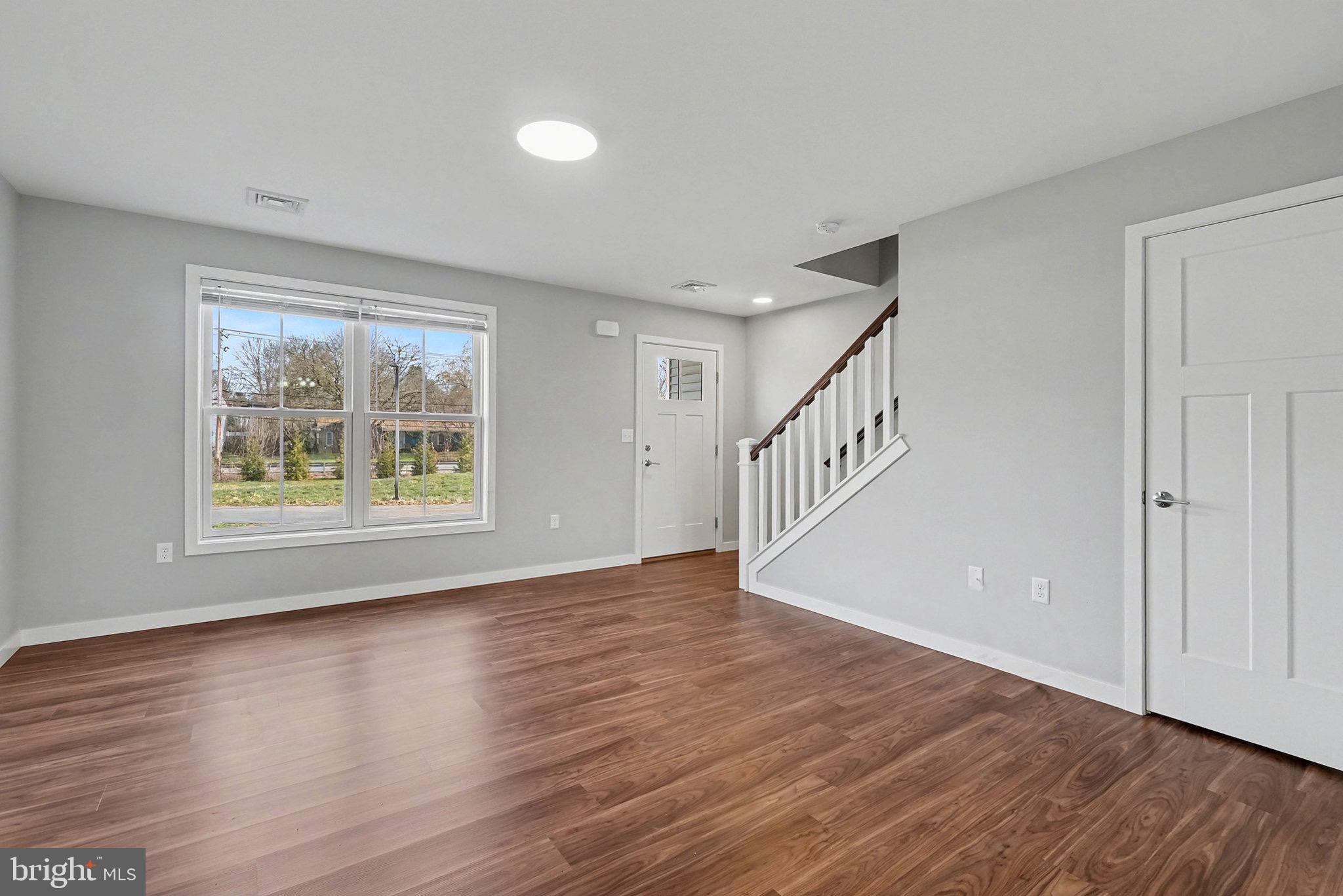 120 Hart Hershey, PA 17033 - Photo 4 of 16 a view of an empty room with wooden floor and a window