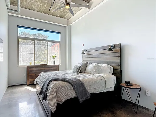 a bedroom with a bed and window