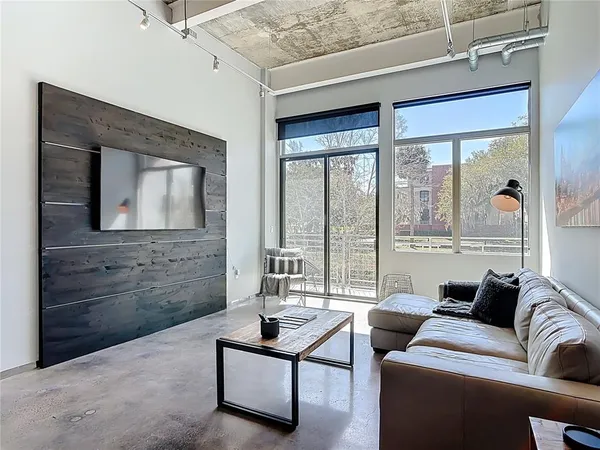 a living room with furniture and a floor to ceiling window
