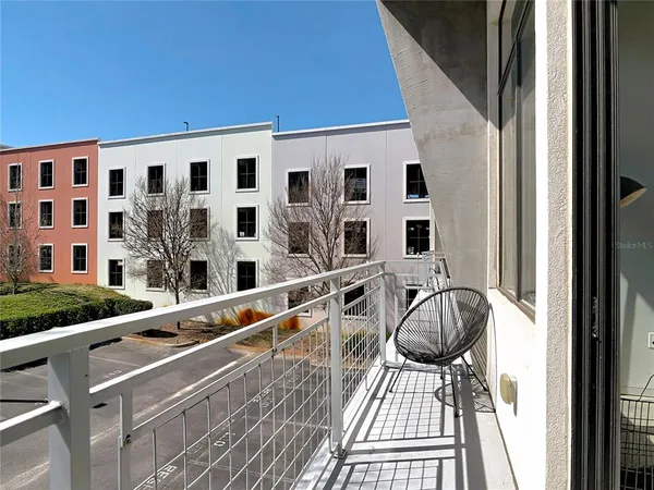 a view of balcony with two chairs and wooden floor