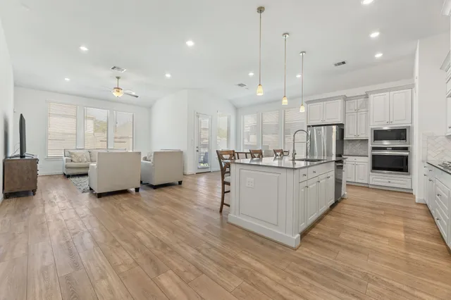 a view of a dining room with furniture and wooden floor