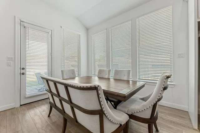 a view of a room with a table and chairs