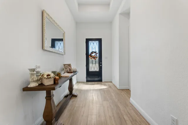 a bathroom with a tub a sink and a window