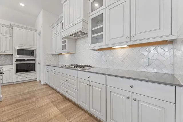 a large bed sitting in a bedroom next to a window