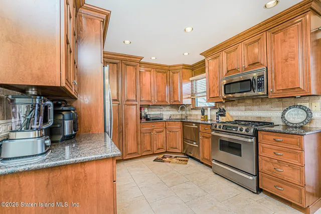 a kitchen with granite countertop a stove top oven sink and cabinets