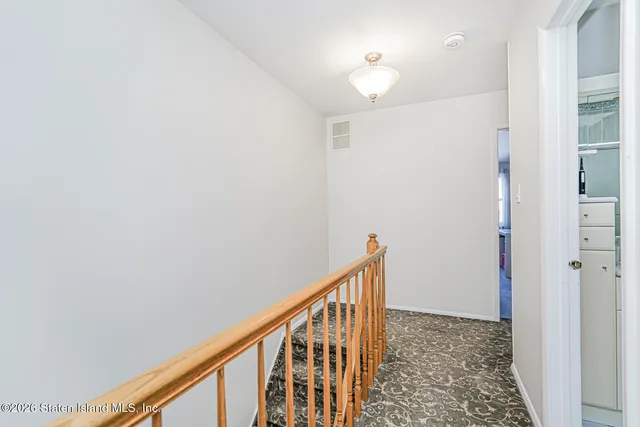 a view of a hallway with wooden floor and entryway