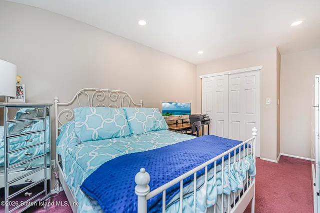a bedroom with furniture and a wooden floor