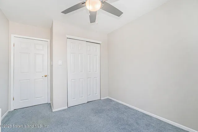 an empty room with a chandelier fan