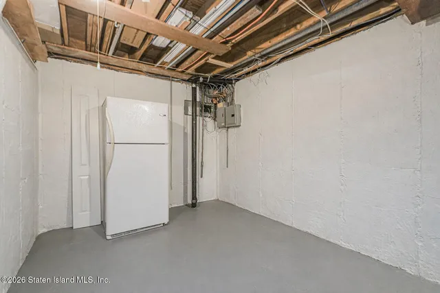 a view of storage and utility room with refrigerator