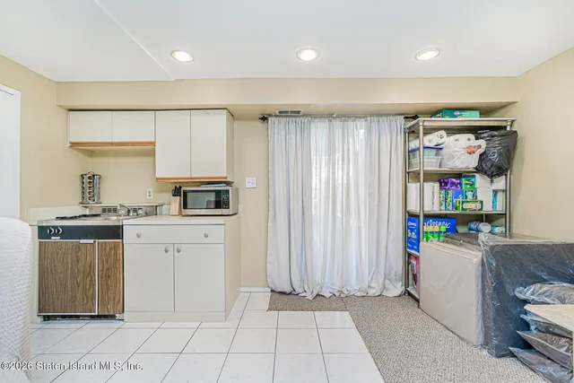 a kitchen with refrigerator and cabinets