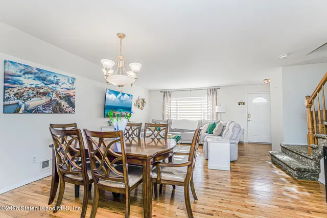 a view of a dining room with furniture wooden floor and a chandelier