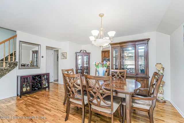 a view of a dining room with furniture wooden floor and chandelier