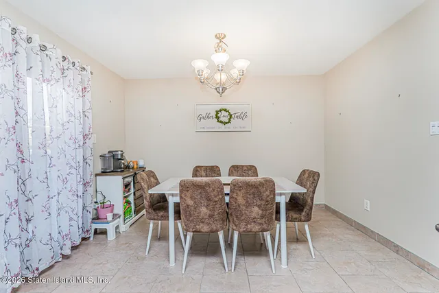 a view of a dining room with furniture and a chandelier