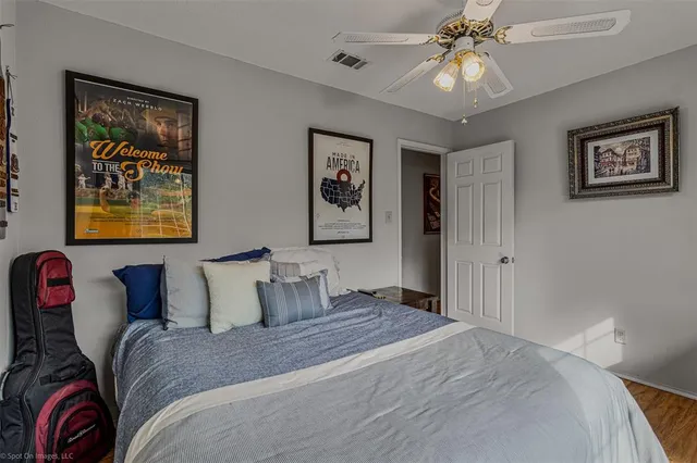 a bedroom with a bed and a painting on the wall