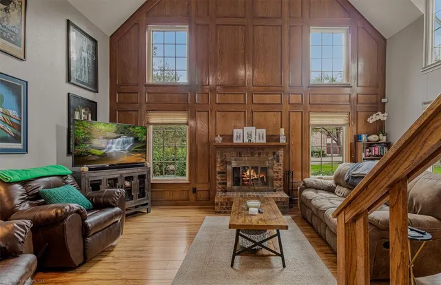 a living room with furniture a fireplace and a flat screen tv