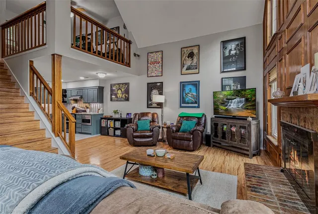 a living room with fireplace furniture and a wooden floor