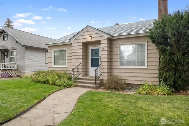 a front view of a house with a garden