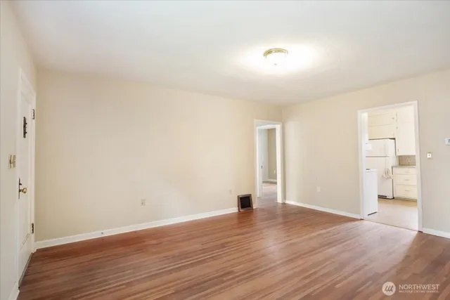 a view of an empty room and wooden floor