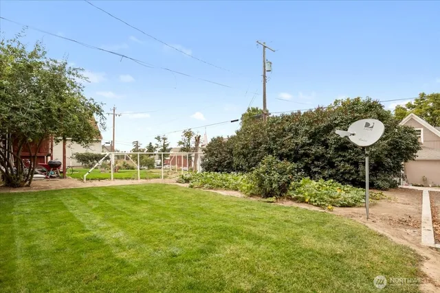 a view of a house with a yard and a garden