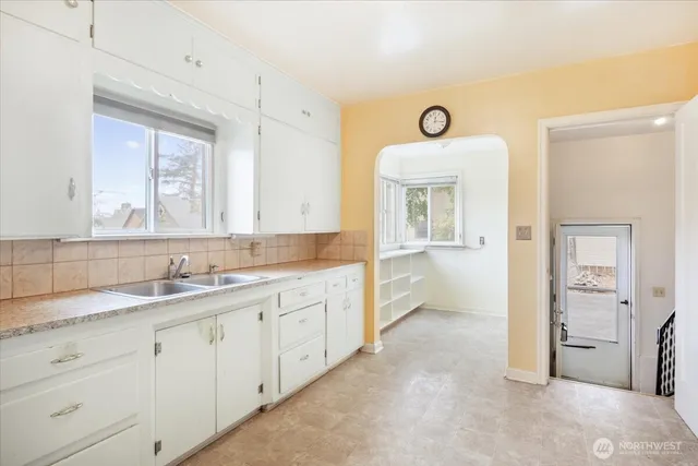 a spacious bathroom with a granite countertop sink and a mirror