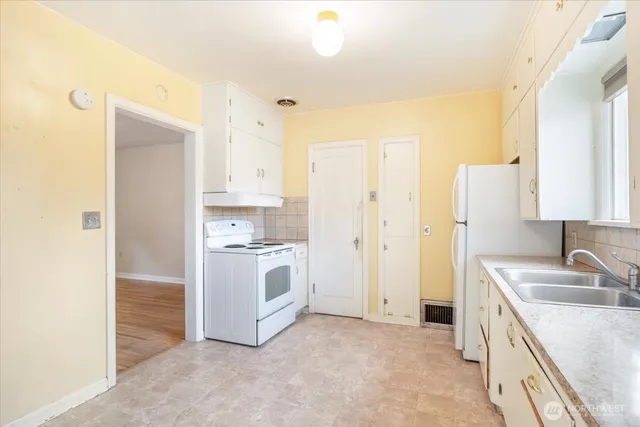 a kitchen with a sink stove and refrigerator