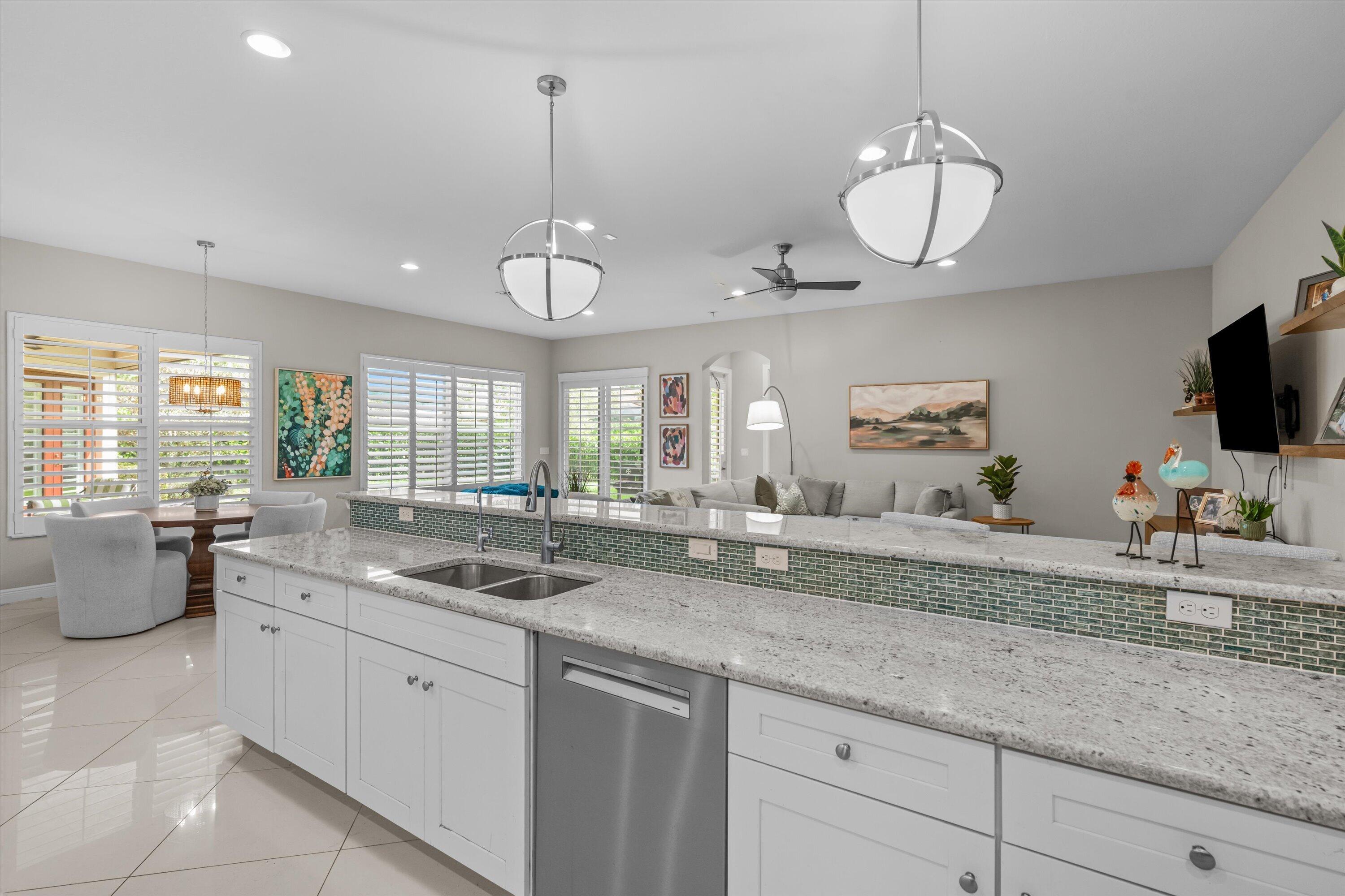 108 Casa Circle Jupiter, FL 33458 - Photo 15 of 53 a kitchen with a sink and dishwasher with wooden floor