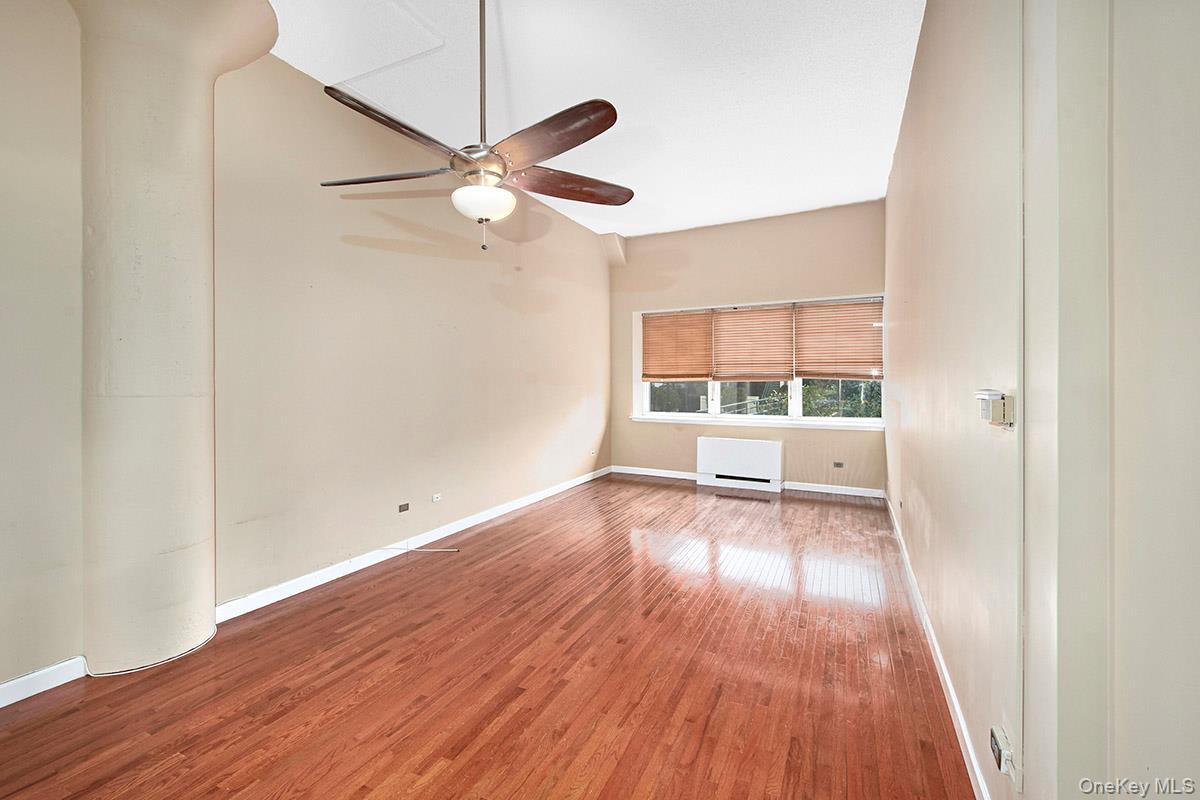 1 Landmark Square, Unit 109 Port Chester, NY 10573 - Photo 11 of 24 an empty room with wooden floor fan and windows